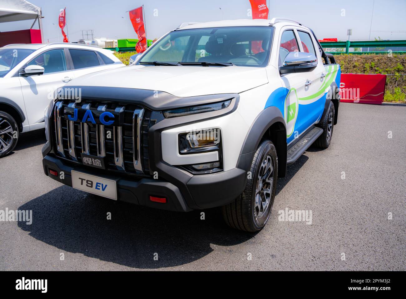 Anhui Province, China – 17042023: EV version of the JAC T9 pickup truck being driven on a track during a test drive. Stock Photo