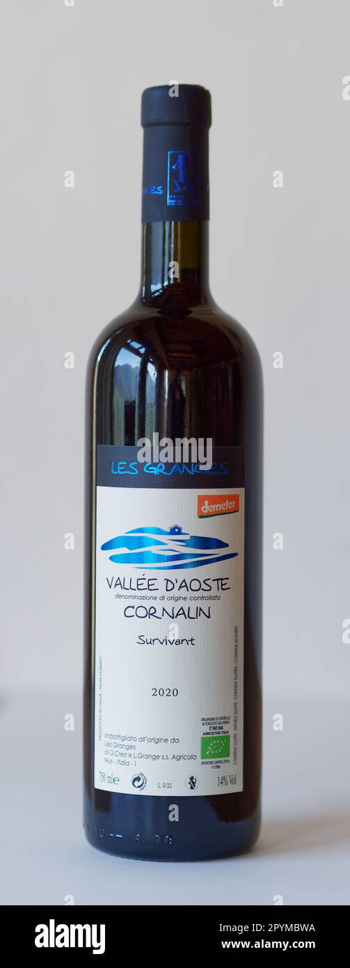 Bottle of  Cornalin wine produced by Les Granges vineyard in Nus in the Aosta Valley, NW Italy. Label dipicts farmhouse and vineyard with stone walls. Stock Photo