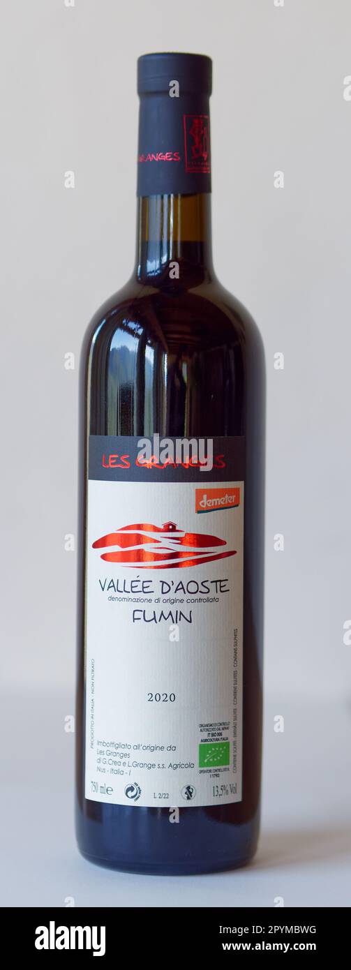 Bottle of  Fumin wine produced by Les Granges vineyard in Nus in the Aosta Valley, NW Italy. Label dipicts farmhouse and vineyard with stone walls. Stock Photo