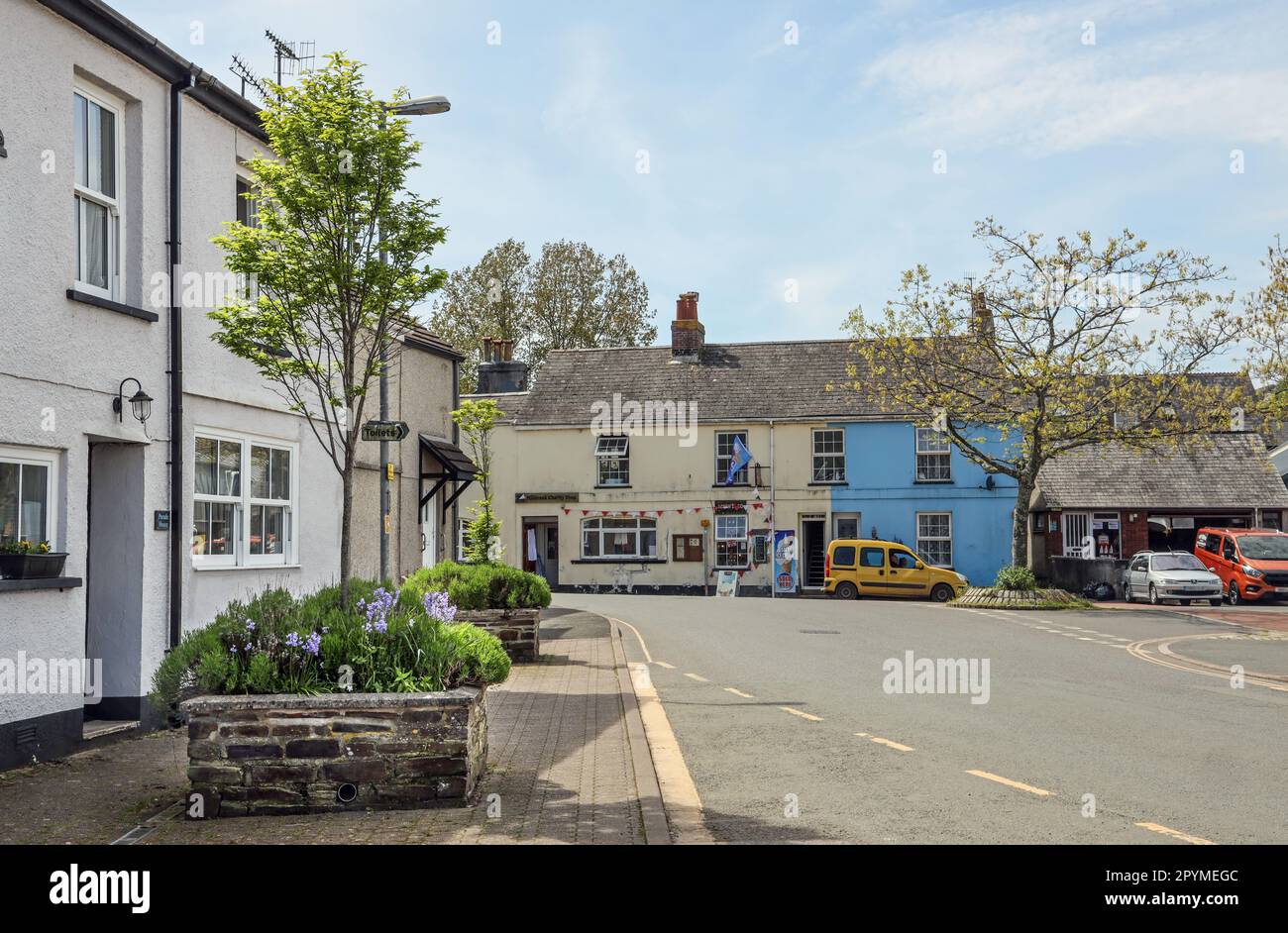 Shops and a garage at West Quay in the village of Millbrook in Cornwall