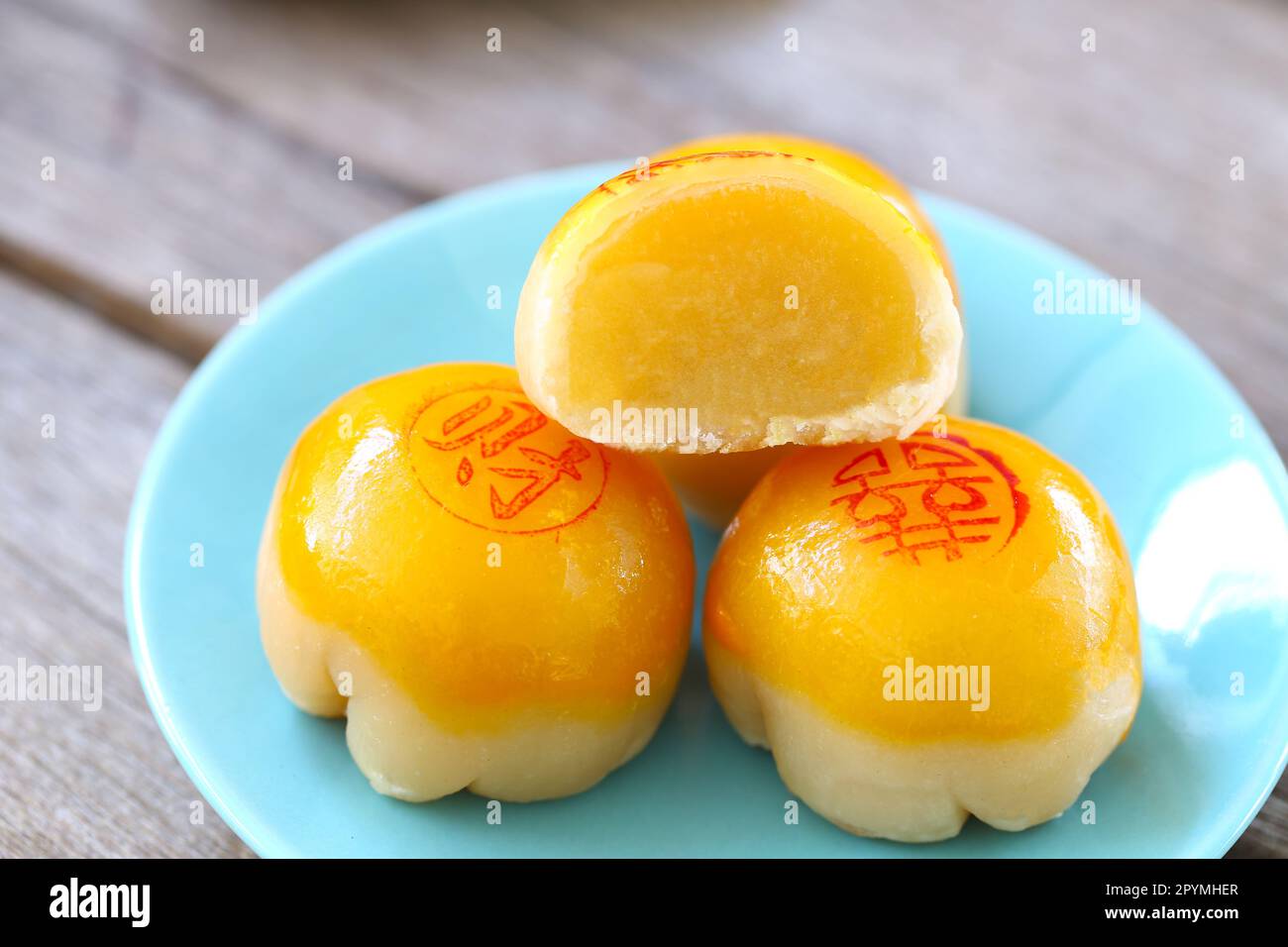 Chinese pastry on the dish and have Chinese alphabet which means Good luck and Good health are on top of dessert. Stock Photo