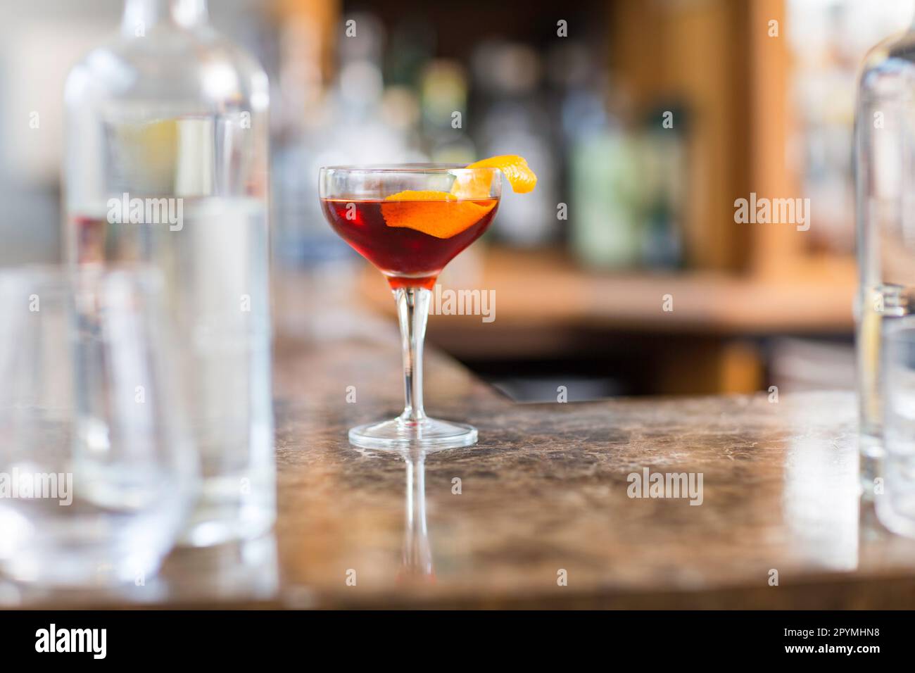 Old fashioned classic cocktail drink in glass on bar counter. Stock Photo