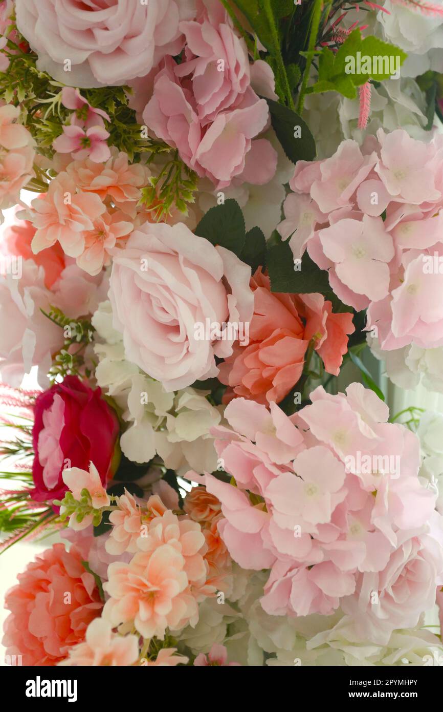 Fake flowers decorate the interior of a hotel, Beautiful colors of fake flowers for your event design. Stock Photo