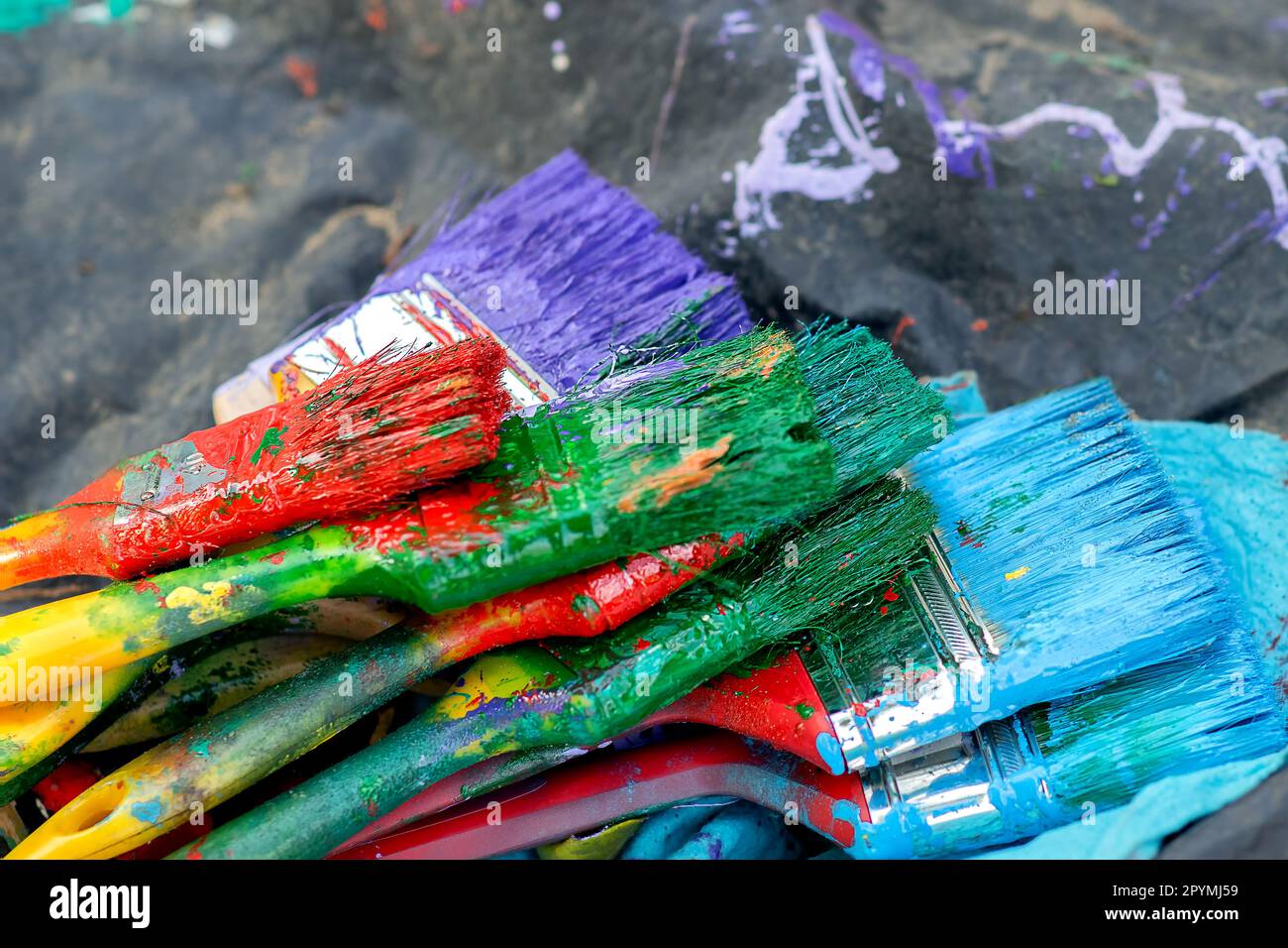 a pile of used brushes, for painting, brushes of different colors, red ...