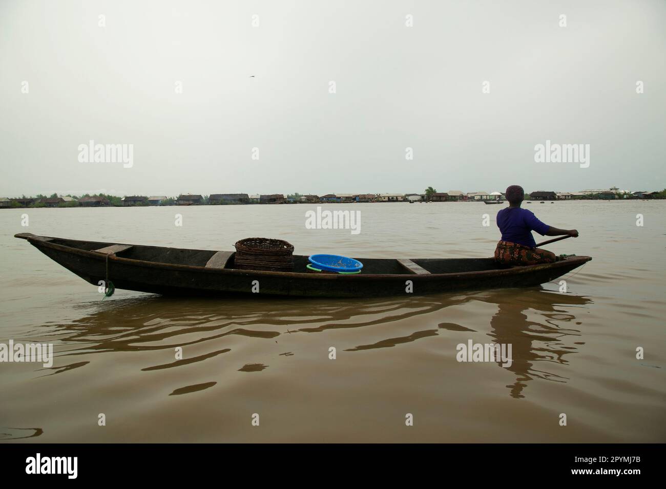 Ondo State, Nigeria - May 2nd, 2023 - Woman fishing through Abereke seaside in a riverine community of Ilaje, Ondo State. Stock Photo