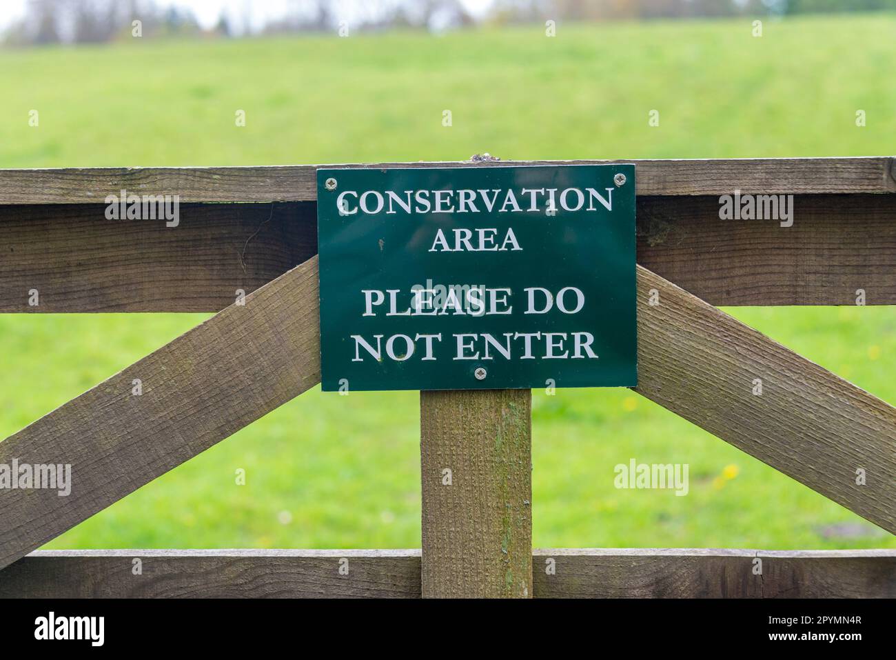 Conservation area, please do not enter sign on a wooden gate. Stock Photo