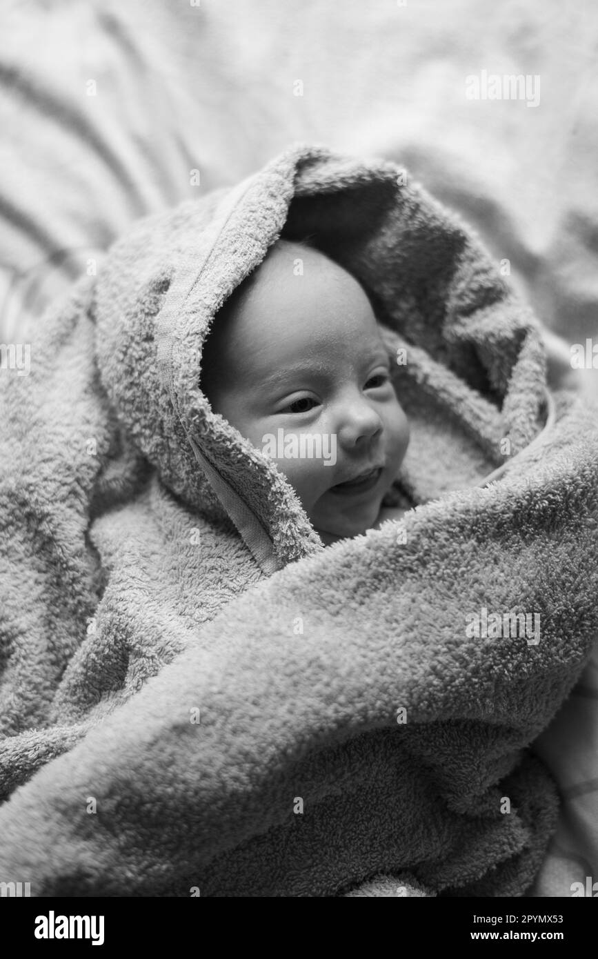 Baby lying in bed Black and White Stock Photos & Images Alamy