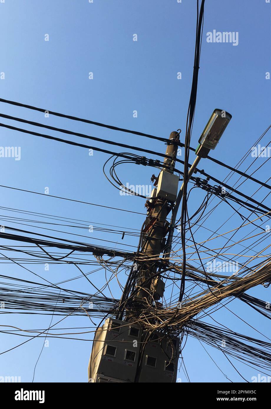 Electricity poles with very natural wires are typical symbols throughout Vietnam Stock Photo