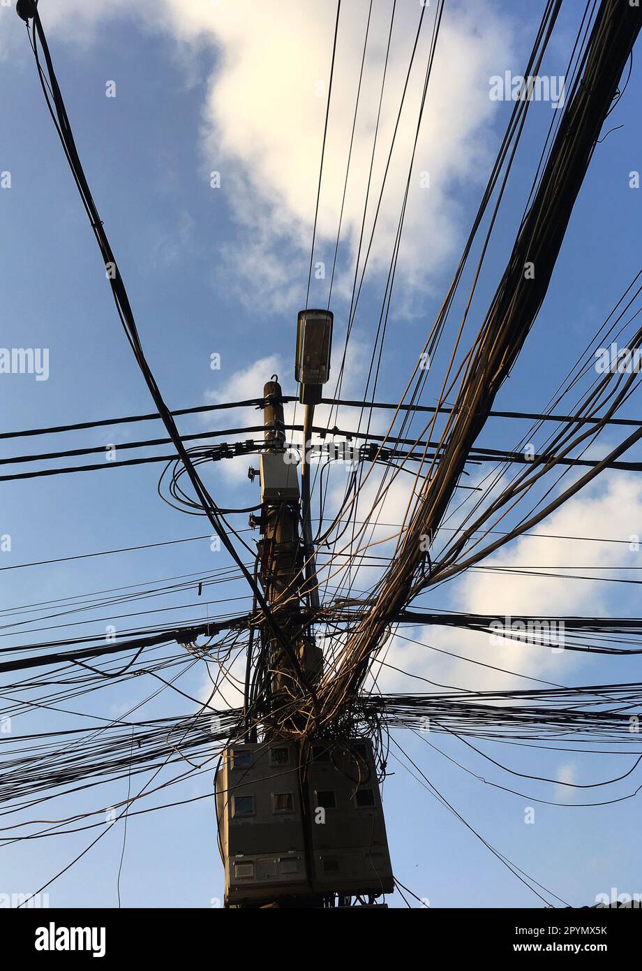 Electricity poles with very natural wires are typical symbols throughout Vietnam Stock Photo