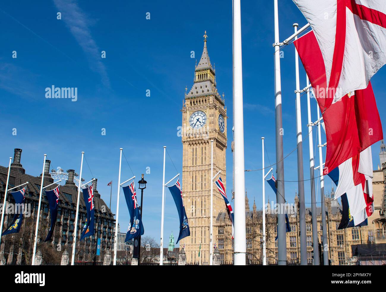 London UK May 3 2023 London's Parliament Square flags fluttering in the wind with the spruced up cleaned  and gilded Westminster's iconic Big Ben and The House of Commons ready as a backdrop or the King's Coronation procession route route  to Westinstimister Abbey for   the coronation of King Charles III and Queen Camilla on 6 May. Credit Gary Blake/Alamy Live Stock Photo