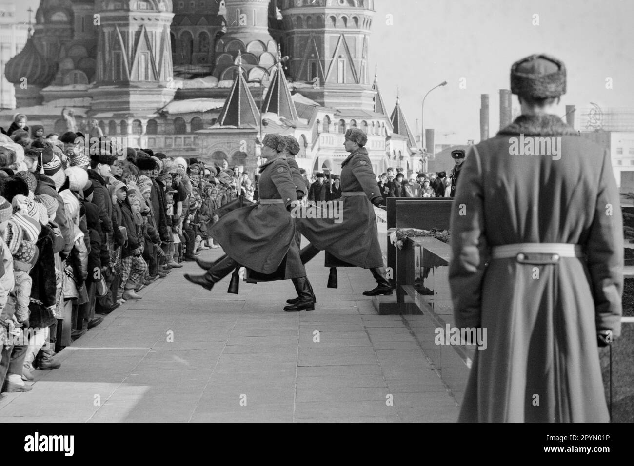 1985: A crowd watches the changing of the honour guard at Lenin’s mausoleum in Moscow’s Red Square in front of St. Basil’s Cathedral. Stock Photo