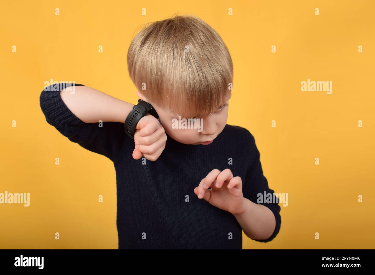 boy child uses a smart watch Stock Photo