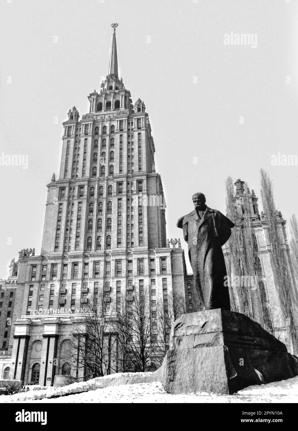 1988: A statue of Ukrainian poet Taras Shevchenko stands in front of the Hotel Ukraina. The Baroque 'wedding cake' style building is one of the so-called 'Seven Sisters' commissioned by Joseph Stalin as part of a plan to modernize Moscow immediately following World War II. Construction began in 1953 and the Hotel Ukraina opened in 1957. Stock Photo