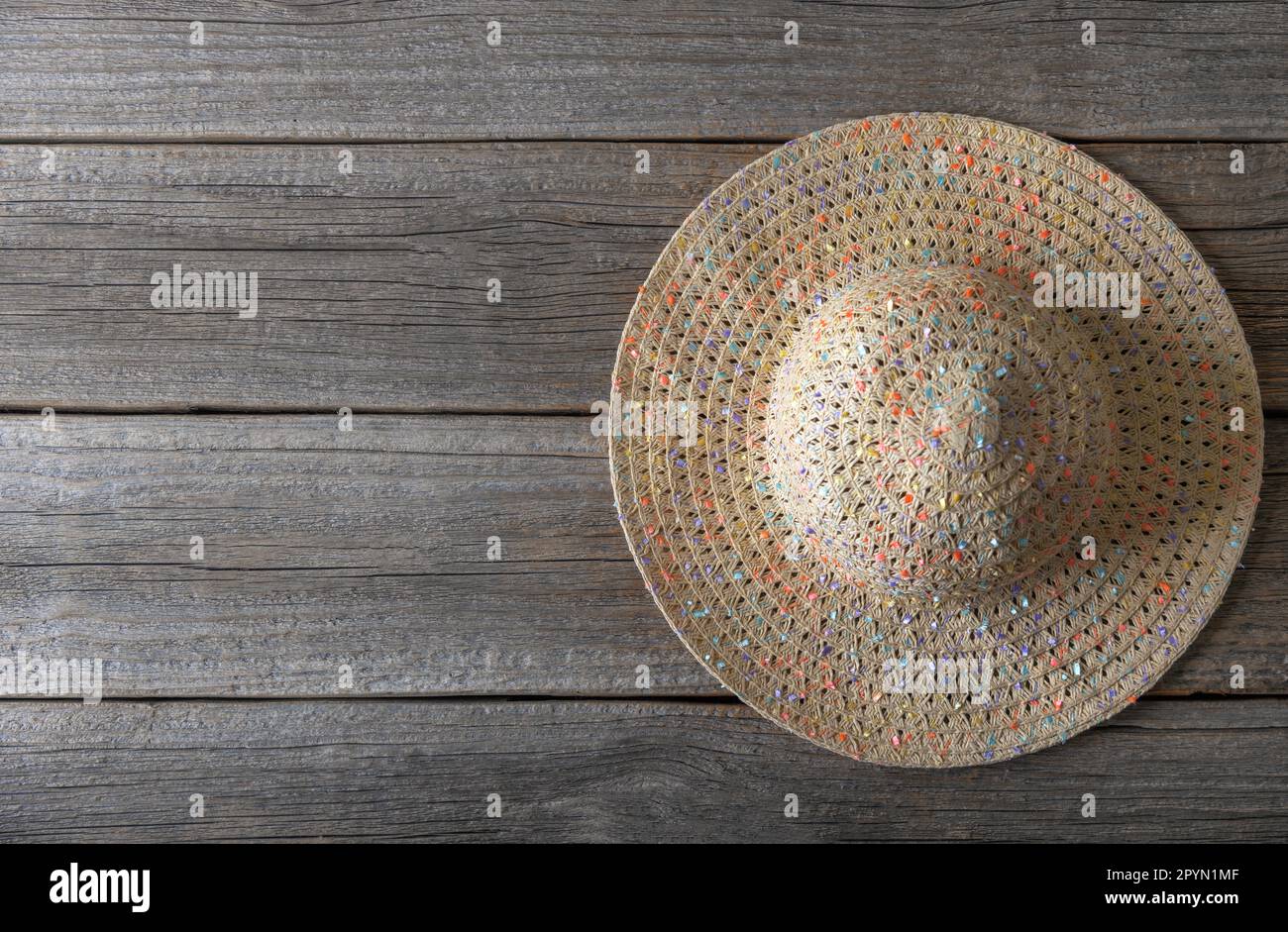 The straw hat lies on wooden boards Stock Photo - Alamy