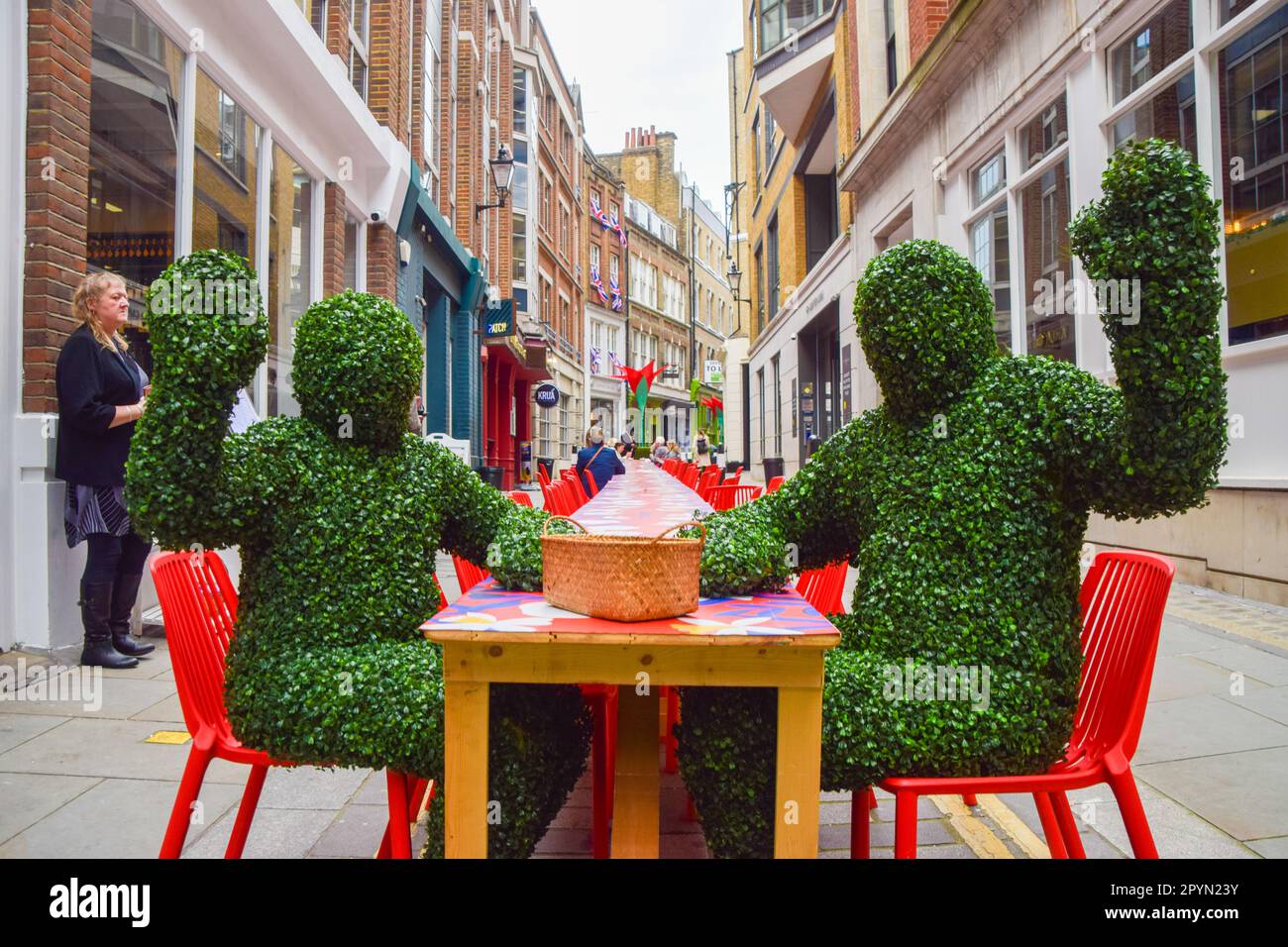 London, UK. 4th May 2023. People dressed as plants greet the visitors at Fleet Street Quarter's Big Picnic, a long table set up in Carter Lane to celebrate the coronation of King Charles III, where people can bring their own lunch and enjoy a picnic in the city. Credit: Vuk Valcic/Alamy Live News Stock Photo