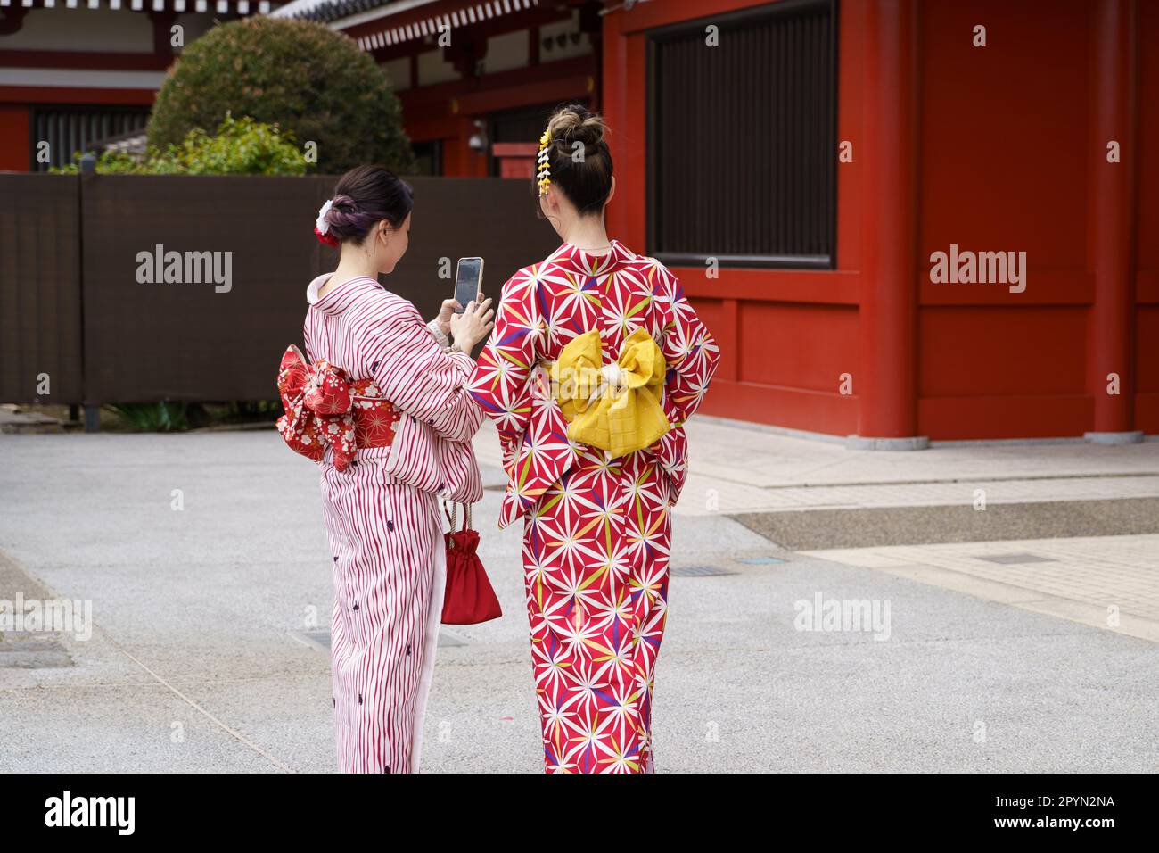 Young girl wearing Japanese kimono standing in Kyoto, Japan. Kimono is