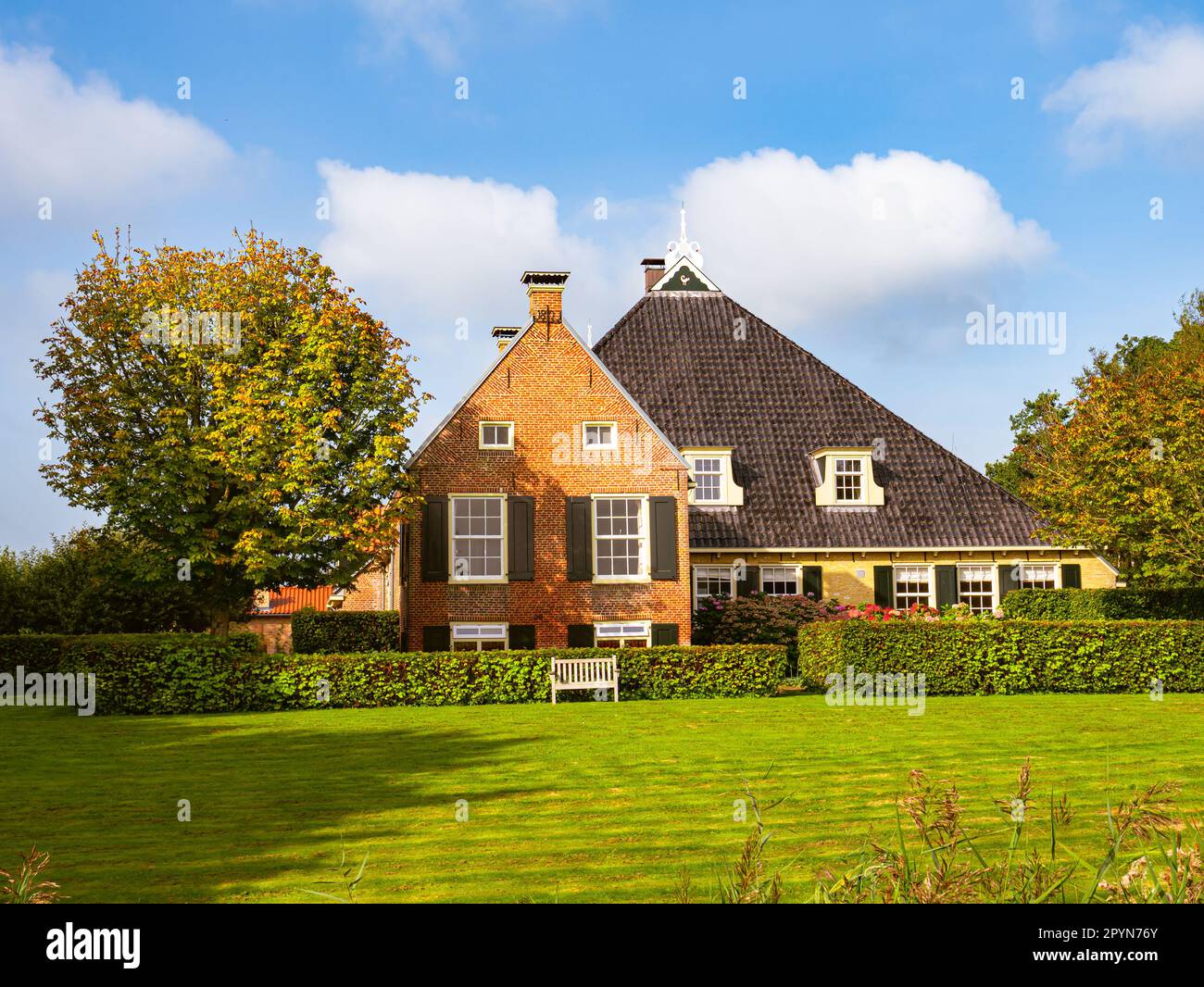 Frisian farmhouse with lawn in autumn near Langweer, Friesland, Netherlands Stock Photo