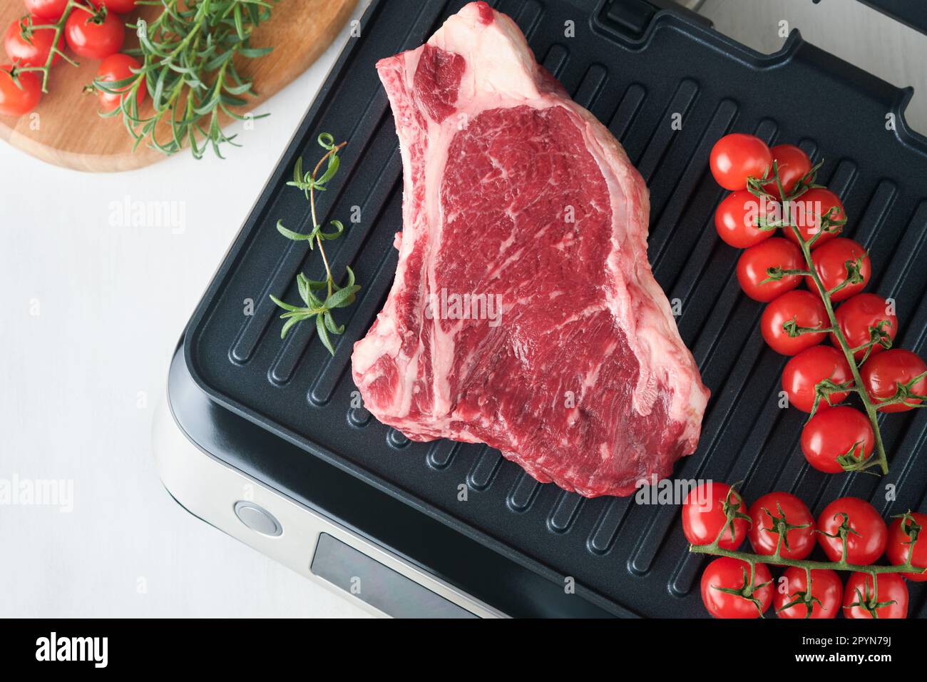 Raw prime steaks on electric grill. Black angus prime meat steaks