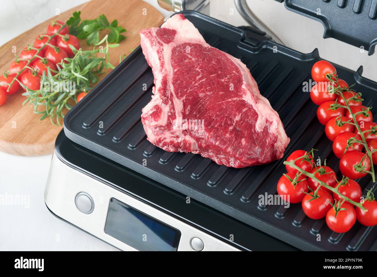 Raw prime steaks on electric grill. Black angus prime meat steaks