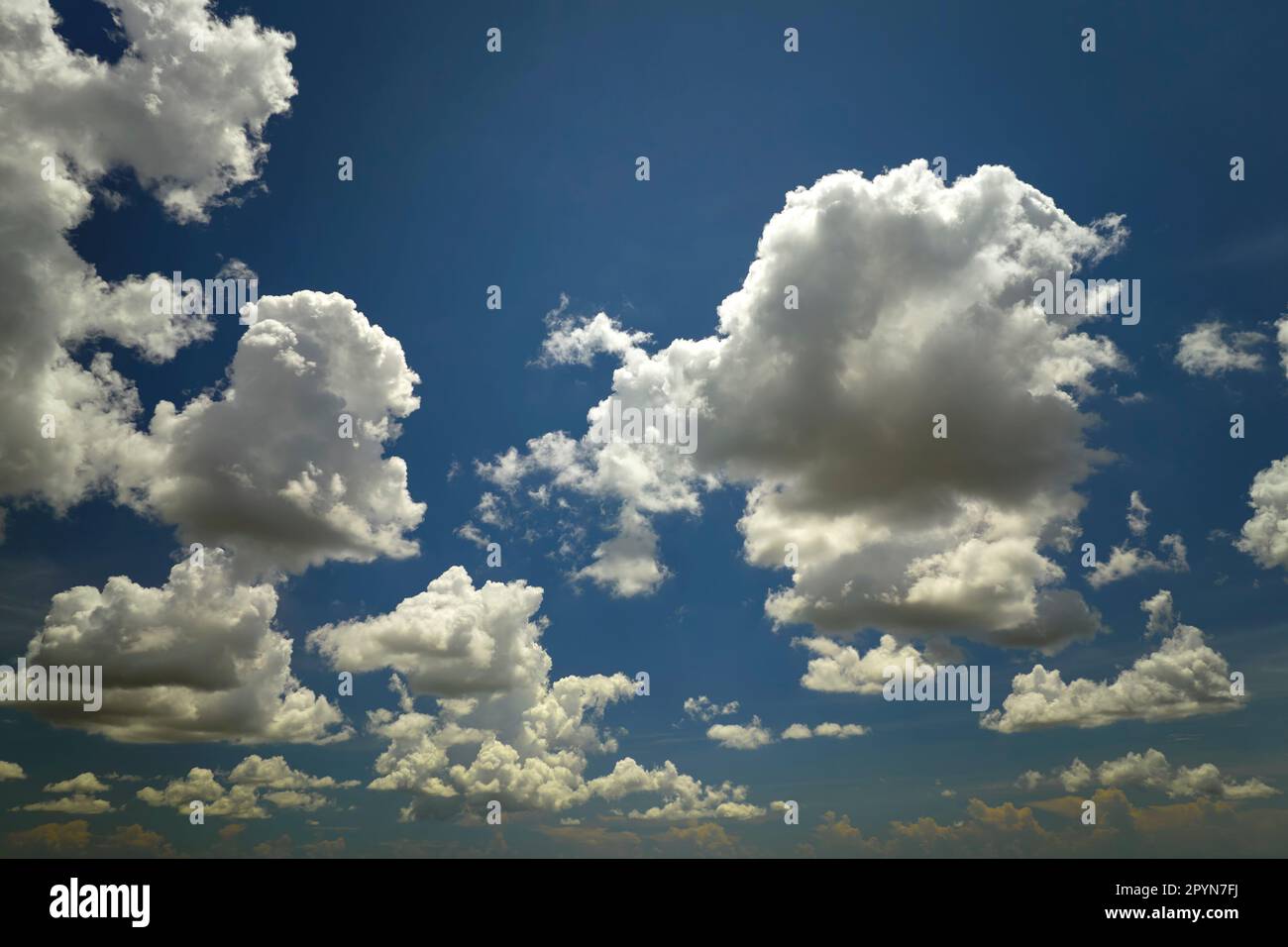 White puffy cumulus clouds on summer blue sky Stock Photo - Alamy