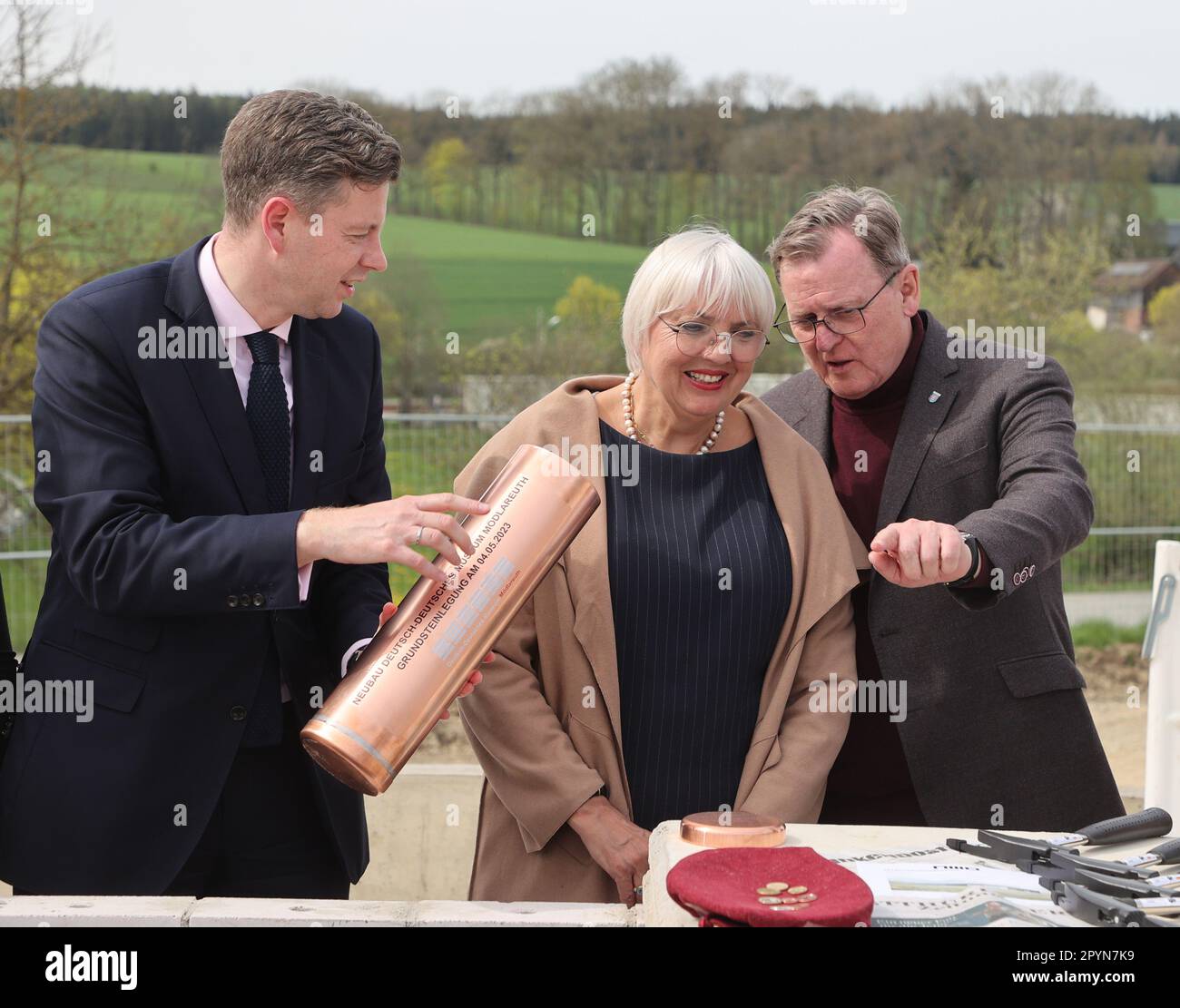 04 May 2023, Bavaria, Töpen: Oliver Bär, (CSU, l-r), District Administrator of Hof County, Claudia Roth (Bündnis 90/Die Grünen), State Minister for Culture and Media, and Bodo Ramelow (Die Linke), Prime Minister of Thuringia, stand together at the laying of the foundation stone for the expansion of the German-German Museum Mödlareuth. In the future, the extension will enable the museum to tell the story of German division and reunification using Mödlareuth as an example, based on the latest research. Photo: Bodo Schackow/dpa Stock Photo