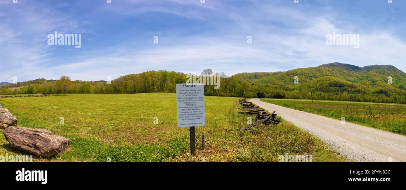 A sign posted at the edge of a beautiful landscape says it is the Tribal land of the Eastern Band of the Cherrokee Tribe in North Carolina. Stock Photo