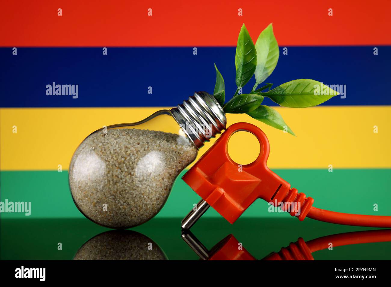 Plug, plant growing inside the light bulb and Mauritius Flag. Green eco renewable energy concept