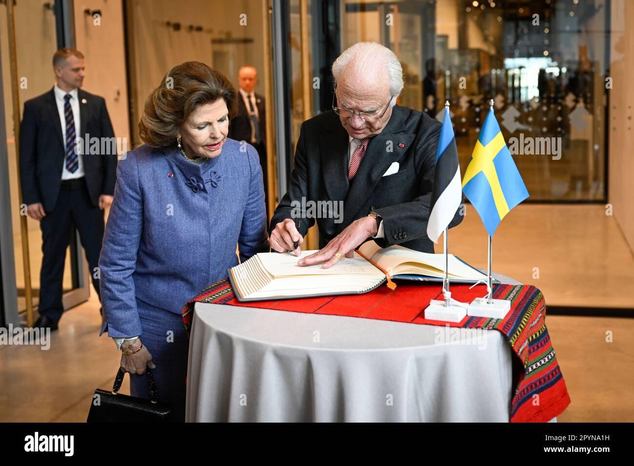 TARTU 20230504Queen Silvia and King Carl write in the guest book when they arrive for a visit to the Estonian National Museum in Tartu. The royal coup Stock Photo