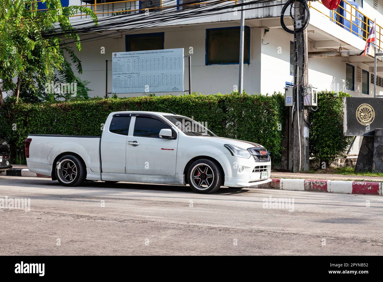 Thailand, Phuket - 03.31.23: Low ride car Isuzu D-Max Pickup with big alloy wheels on the road in the city with traffic. Stock Photo