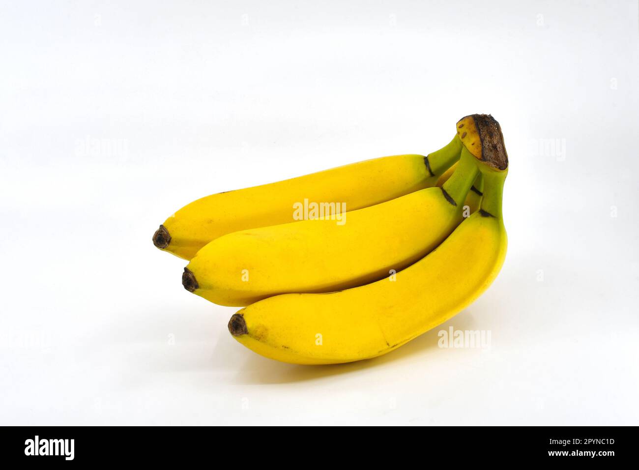 Bunch of fresh ripe bananas isolated on a plain white background. Copy space. Stock Photo