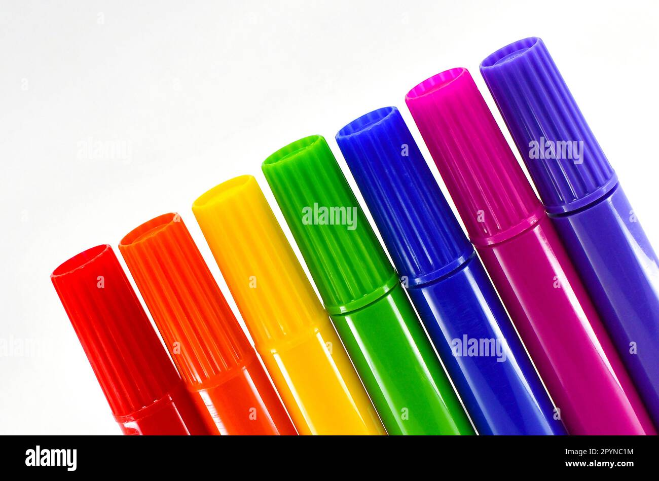 Row of coloured market pens isolated against a plain white background. Copy space. No people. Stock Photo