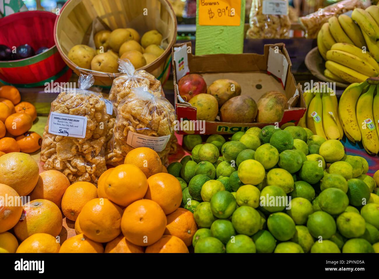 Bryson, North Carolina, USA - April 19, 2023: Darnell Farms open air market with tables of fruit and  bags of pork skins for sale. Stock Photo