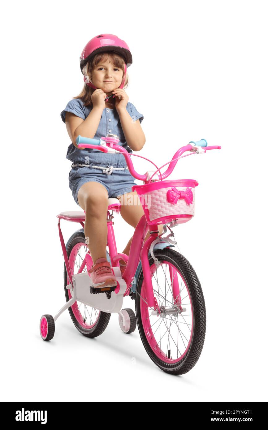 Girl putting on a helmet and sitting on a bicycle with training wheels