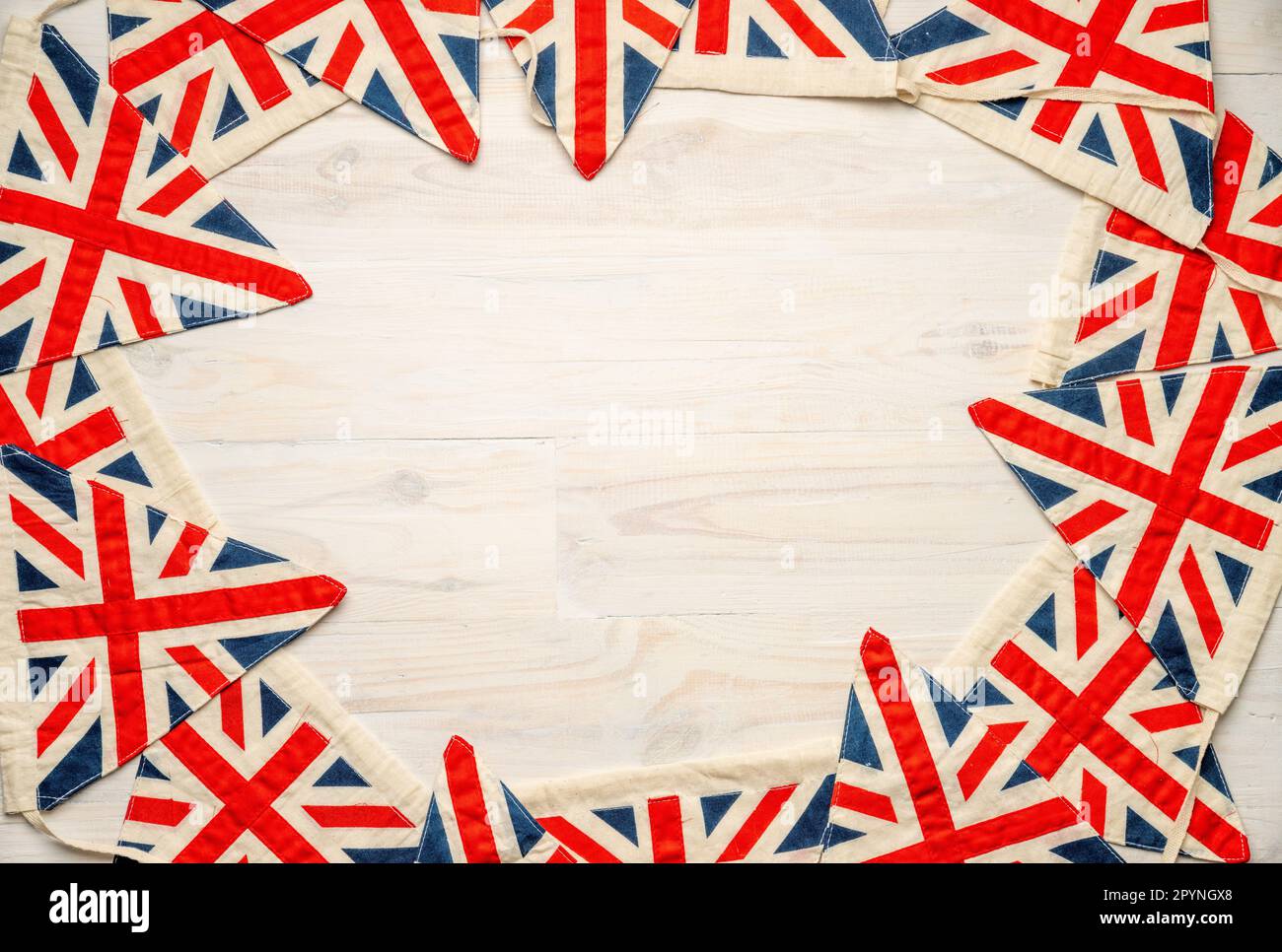 Union Jack bunting on wooden board with central copy space Stock Photo