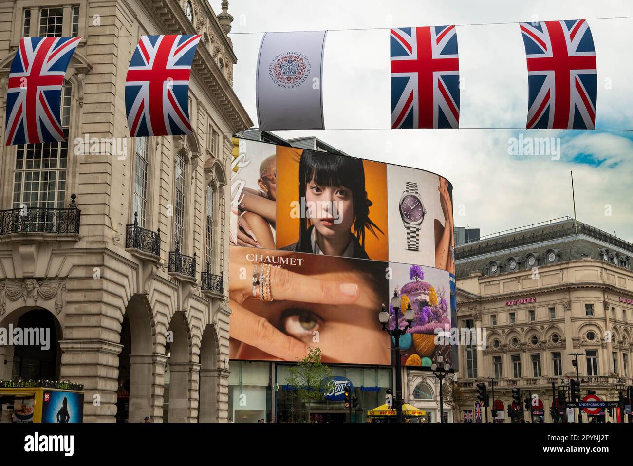 Union Jack flags along a coronation flag are seen in Piccadilly ahead
