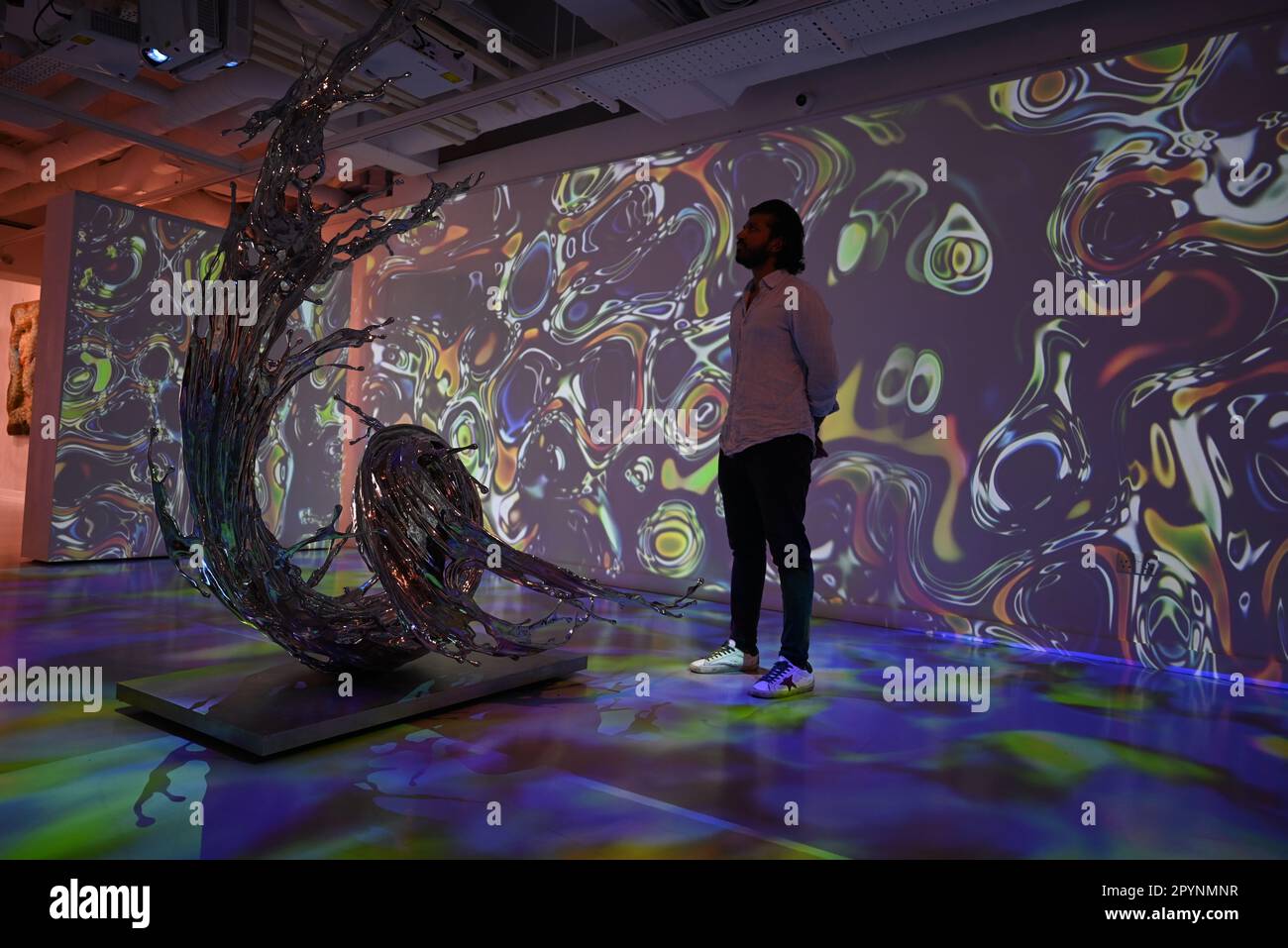 Digital artist OSF surrounded by immersive art by Agoria and sculpture