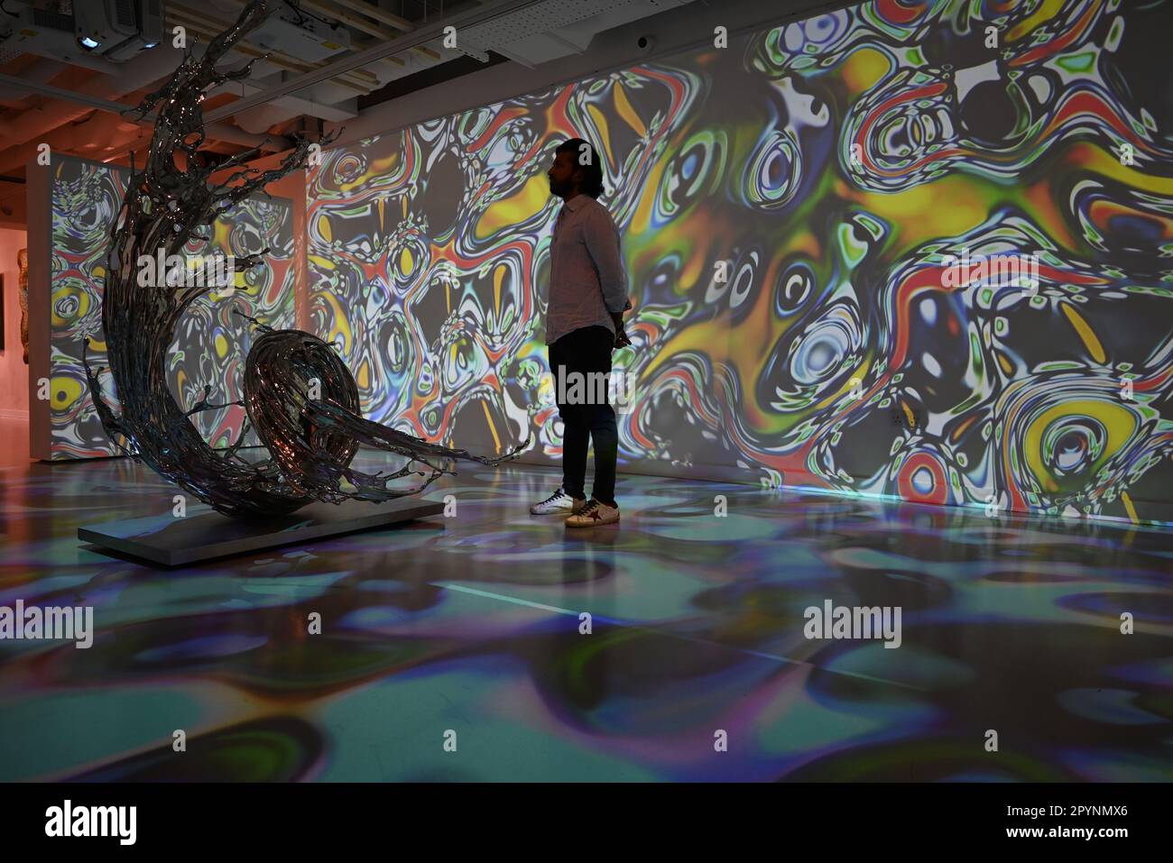 Digital artist OSF surrounded by immersive art by Agoria and sculpture