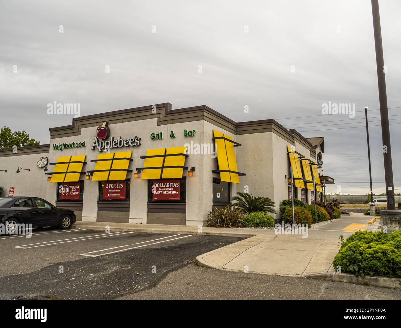 A colorful Applebees restaurant with large banners advertising specials