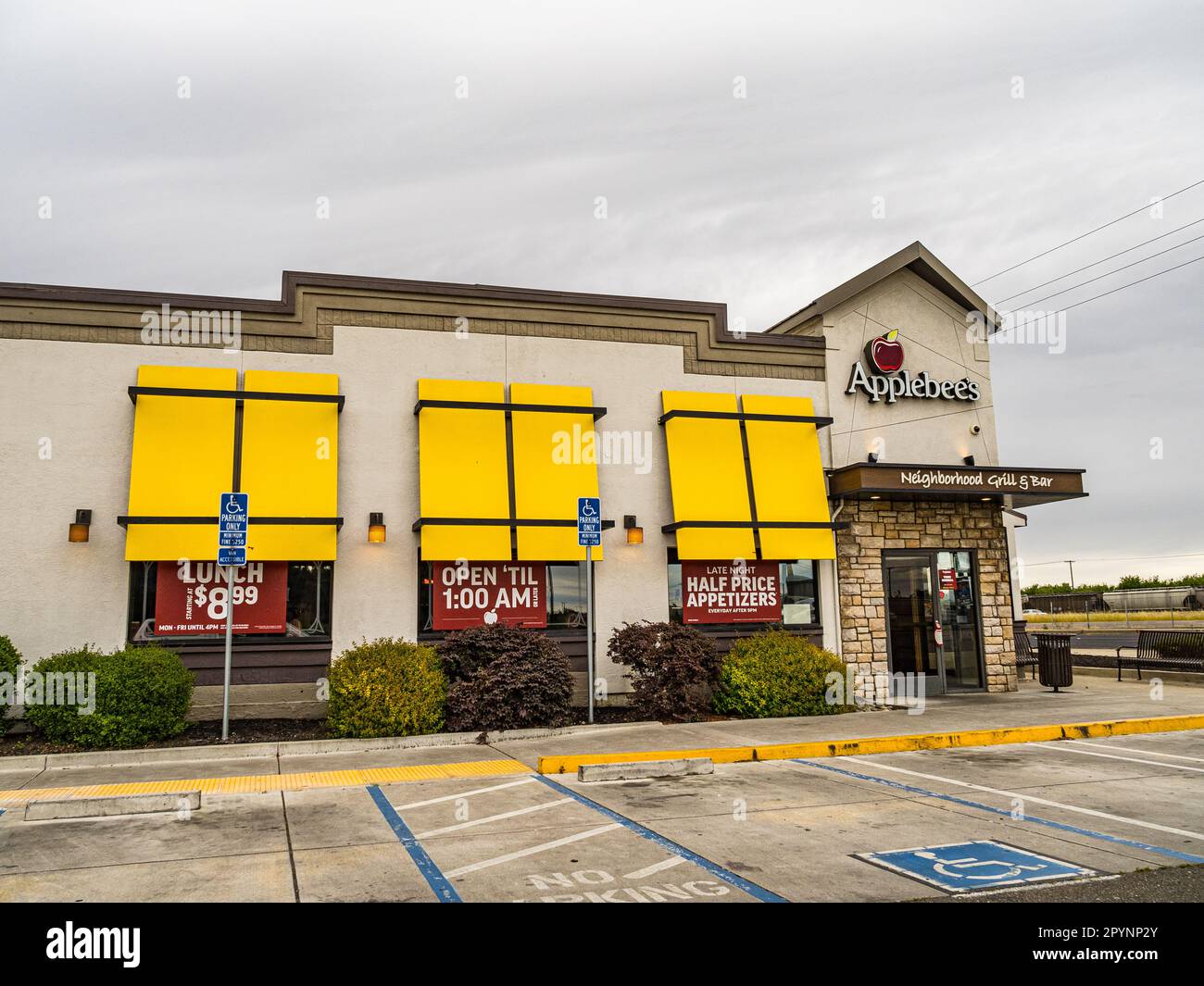 A colorful Applebees restaurant with large banners advertising specials
