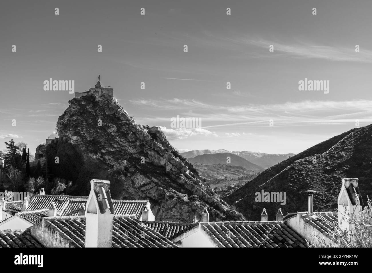 Black and white View of the Andalusian town of Castril at the foot of a rock on a hill Stock Photo
