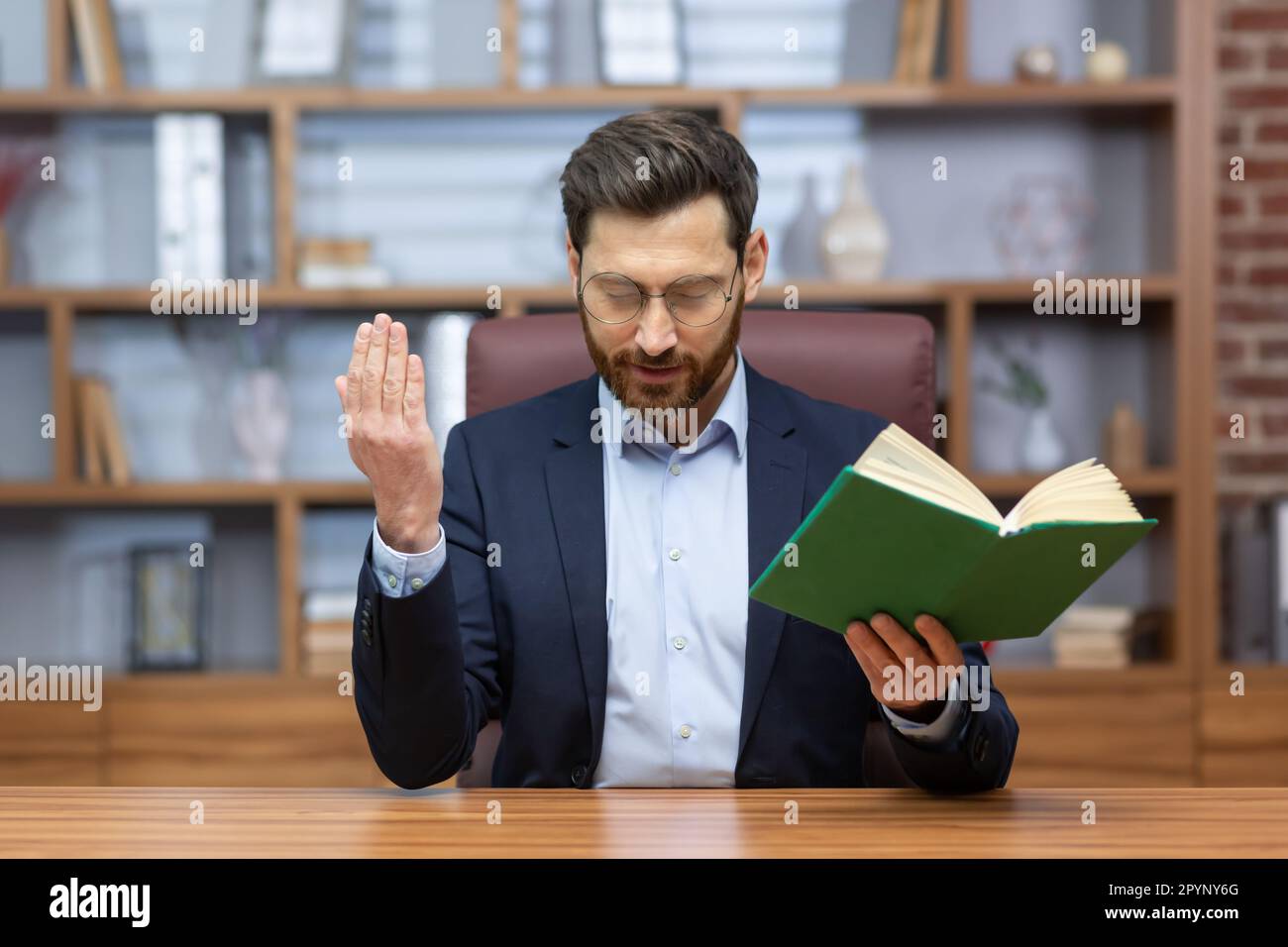 Portrait of a young man in a suit, a pastor. a priest sitting in the