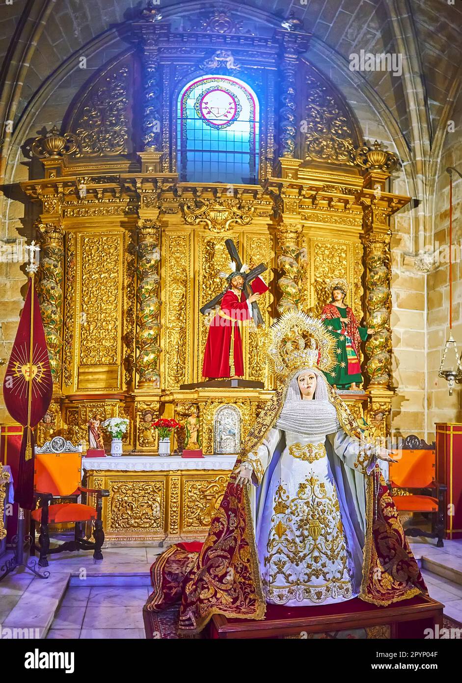 EL PUERTO, SPAIN - SEPT 21, 2019: The statue of Virgin Mary in ornate chapel of Great Priory Church, decorated with carved gilt altarpiece, on Sept 21 Stock Photo