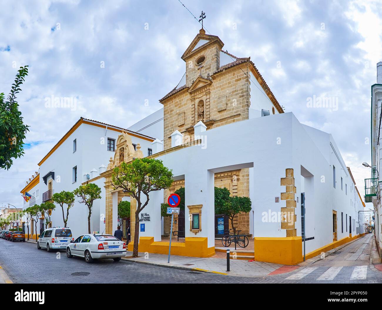 EL PUERTO, SPAIN - SEPT 21, 2019: The facade of historic Convent of San Miguel Arcangel with stone gate in the foreground, on Sept 21 in El Puerto Stock Photo