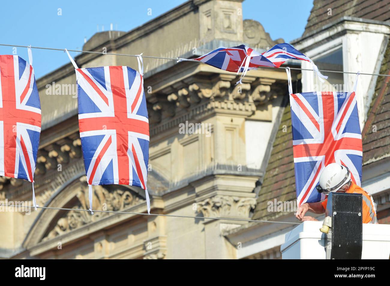 UK. 4th May 2023. British Union Jack flags are being hung across Fore Street in Hertford before the coranation of King Charles the III.Hertford, Andrew Steven Graham/Alamy Live News Stock Photo