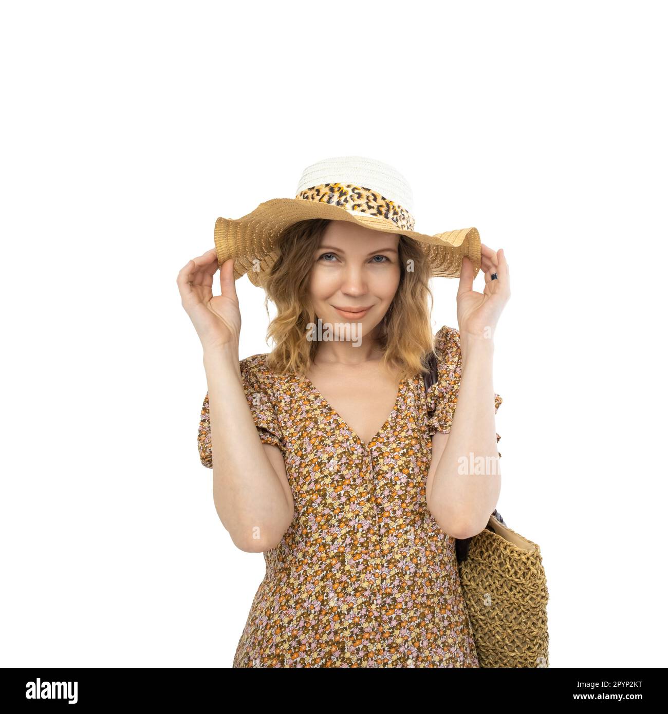 Contented pretty mature 40 year old woman in hat and dress isolated on white background. Stock Photo