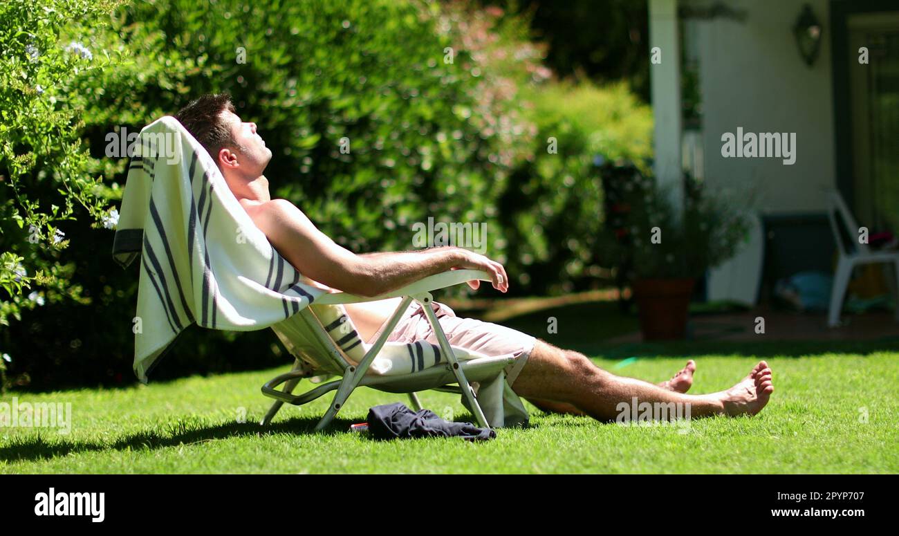 Man relaxing outside home backyard sunbathing Stock Photo Alamy