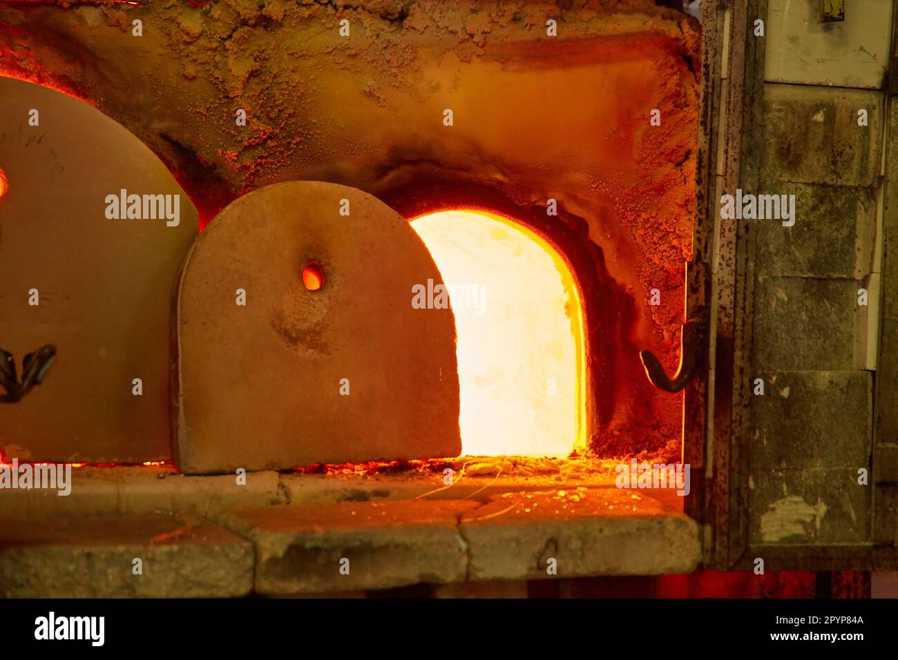 Glass blower at work. The glassblower blows a glass vase. glass