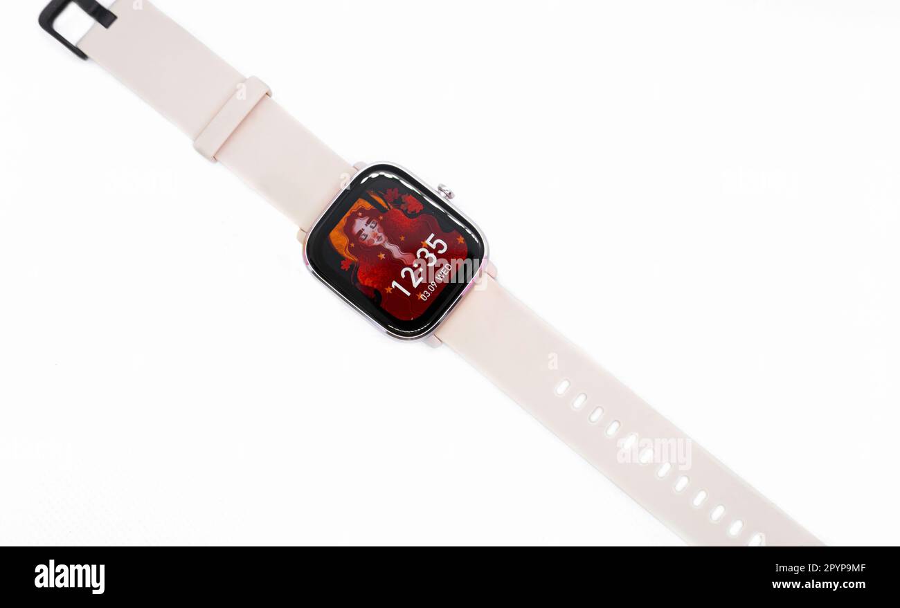 A modern smart watch sitting against a clean white background Stock Photo