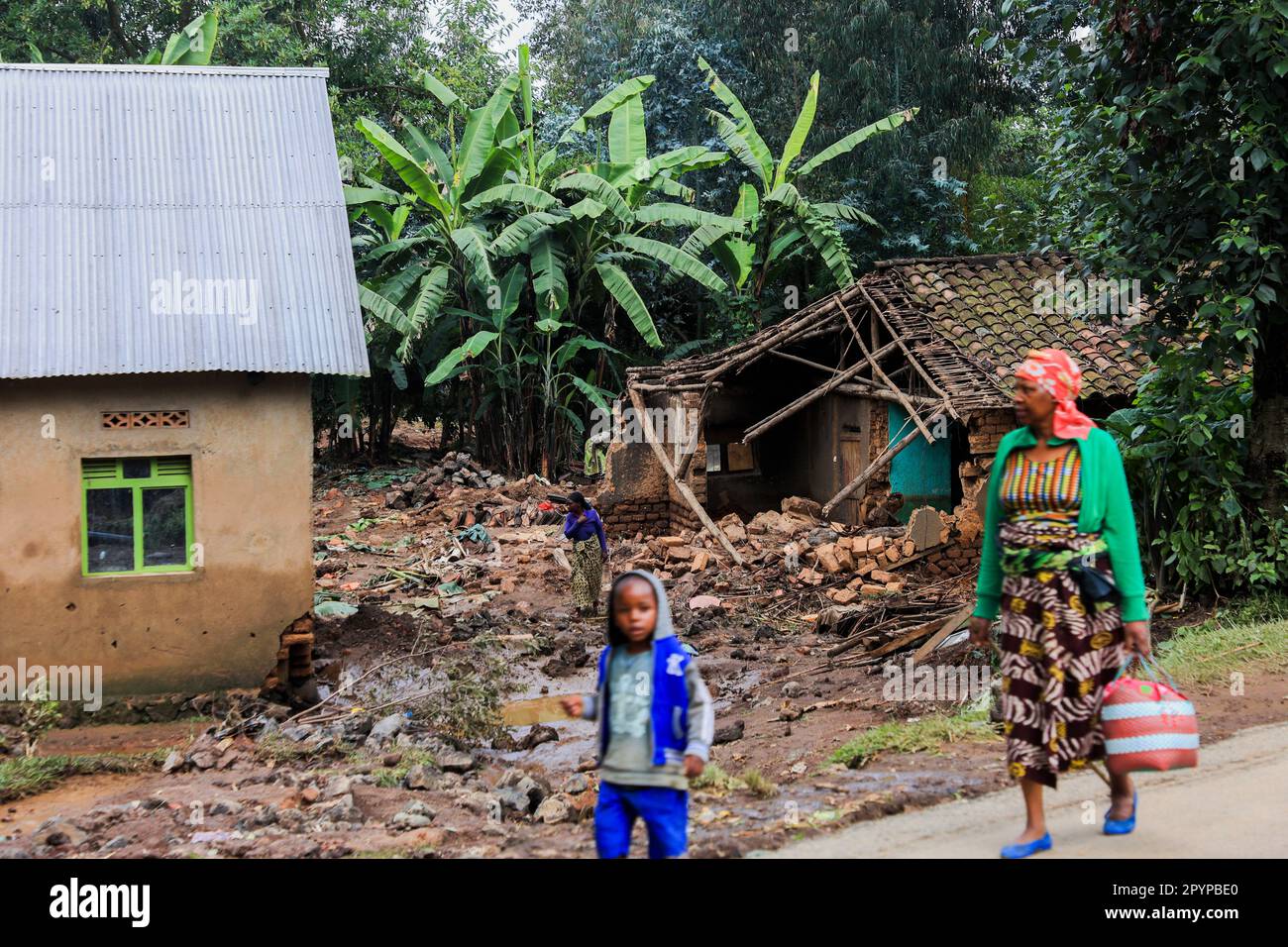 Rubavu, Rwanda. 4th May, 2023. People walk by houses damaged in flash