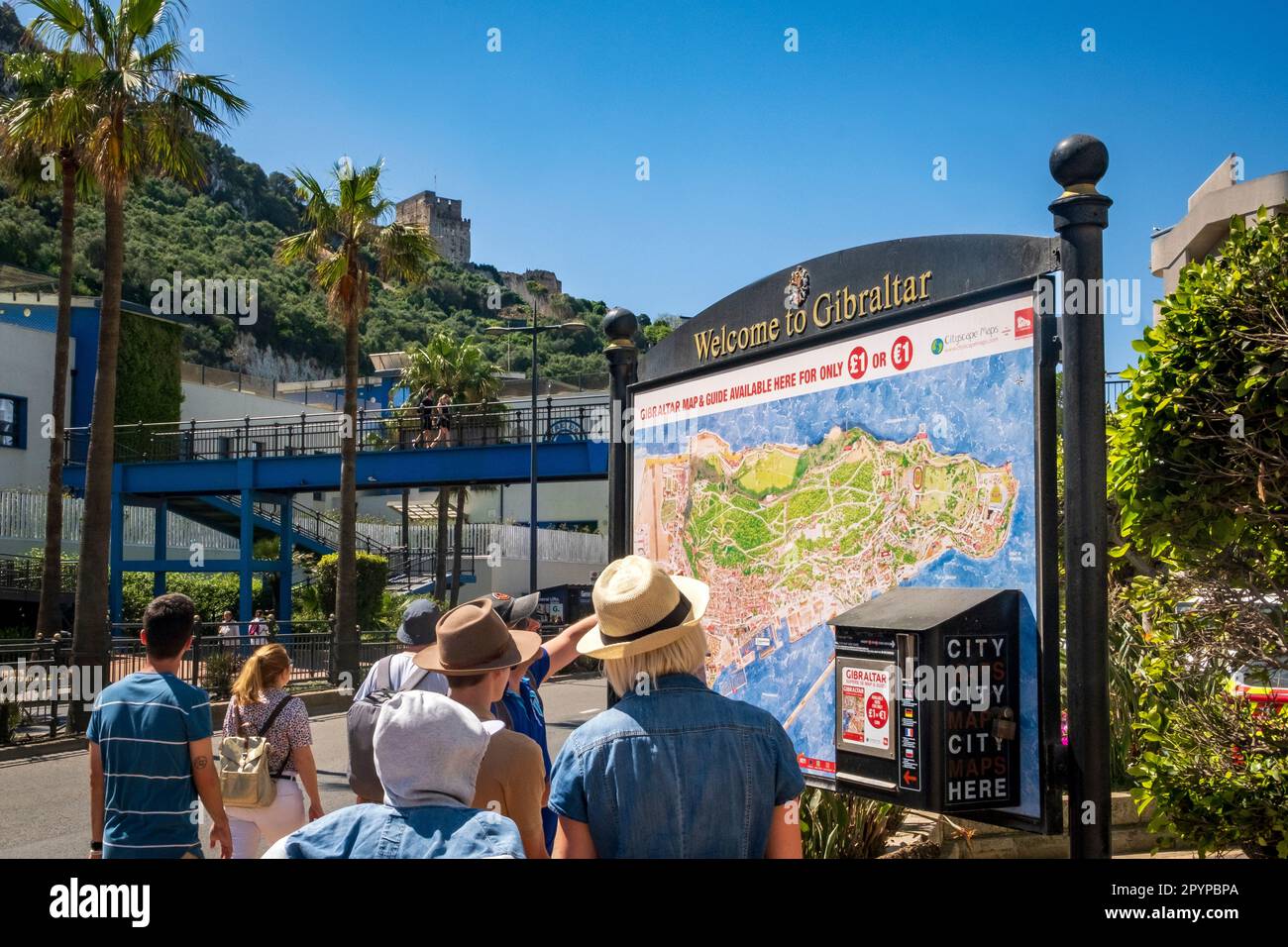 Tourists look at a 'Welcome to Gibraltar' sign and map Stock Photo